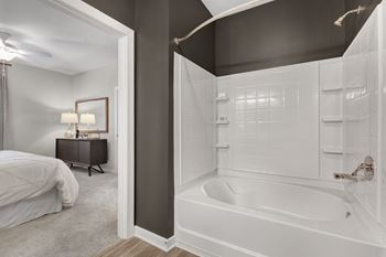 Large Soaking Tub In Master Bathroom with A Tile Surround at Abberly Avera Apartment Homes by HHHunt, Virginia, 20109